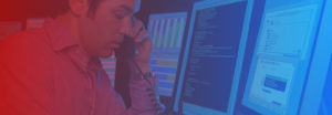 Image of someone on the phone in front of multiple computers for free web application penetration testing banner