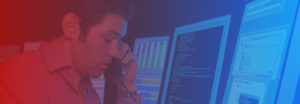 Image of someone on the phone in front of multiple computers for free web application penetration testing banner